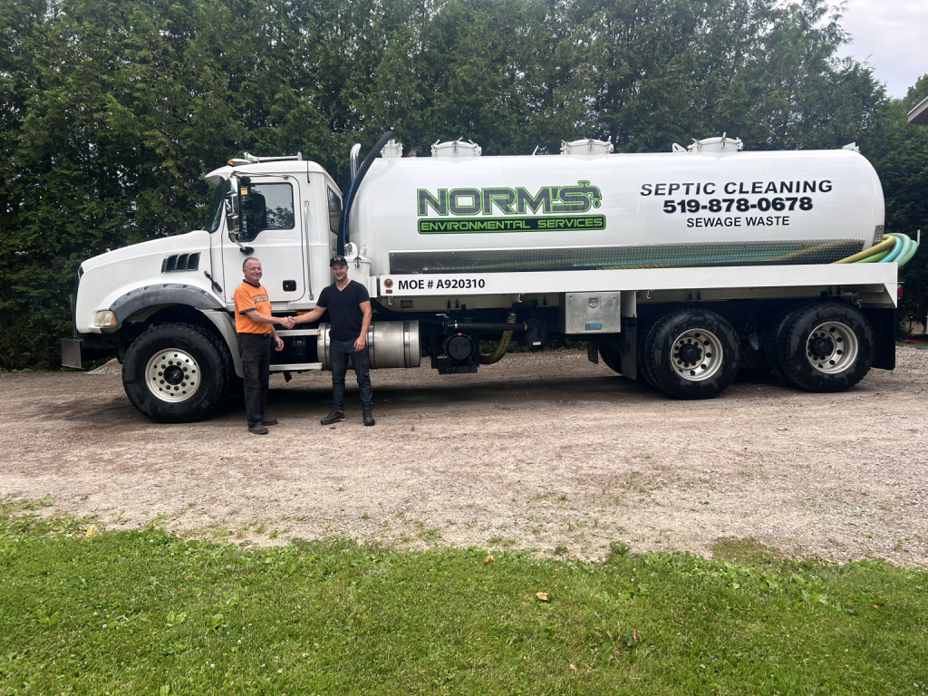 Dom with John Bissell, previous owner of Norm’s Environmental Service, during the transition of the business